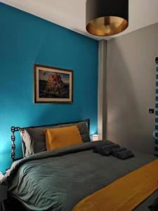 a blue bedroom with a bed with a blue wall at fruit tower 300Mbps in Thessaloniki