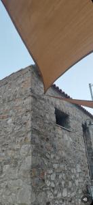 a stone building with a window in a brick wall at Vaki's country house in Pylos