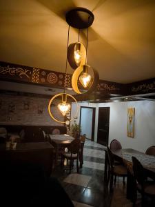 a dining room with tables and chairs and lights at Lawenda in Białka Tatrzanska