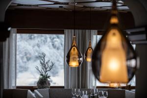 a dining room with a table with glasses and a chandelier at die Aussicht in Finkenberg