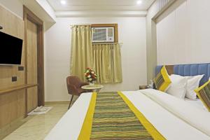 a hotel room with a bed and a television at Hotel Mehul Int-New Delhi in New Delhi