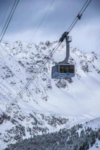 a ski lift going up a snow covered mountain at Glacier Rock guesthouse in Solda