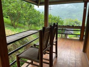 two chairs sitting on a porch with a view at Sapa Orange Homestay in Sa Pa