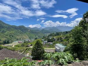 a view of a village with a river and mountains at Sapa Orange Homestay in Sa Pa