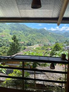 a window with a view of a mountain view at Sapa Orange Homestay in Sa Pa