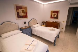 a bedroom with two beds and a dresser at Casa di Anna in Pistoia