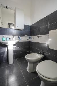 a bathroom with a white toilet and a sink at Silvia Casa Vacanze in Porto Cesareo