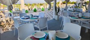 a group of tables and chairs on a patio at Silvia Casa Vacanze in Porto Cesareo