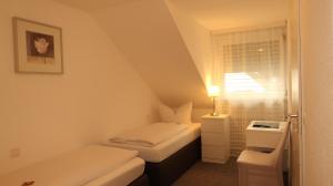 a small room with a small bed and a window at Hotel Zur Kripp in Koblenz