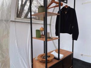 a shelf with a jacket and a coat on it at Hotel Harzresidenz in Thale