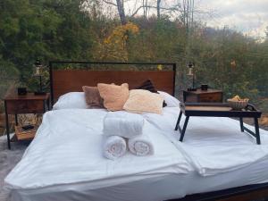 a white bed with towels on it with a table at Hotel Harzresidenz in Thale