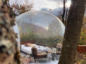 a igloo house with a bed and a table and a tree at Hotel Harzresidenz in Thale