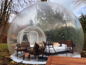 a glass igloo with a table and a room in it at Hotel Harzresidenz in Thale