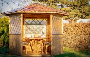 un cenador de madera con una mesa. en Ostseegruss, en Rostock