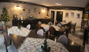 a restaurant with tables and chairs and a christmas tree at Lawenda in Białka Tatrzanska