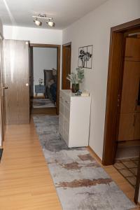 a living room with a white refrigerator in a room at Taros Home - Deluxe Apartment in Herrenberg