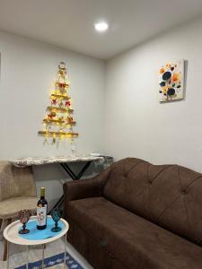 a living room with a couch and a christmas tree at Kitesa's cozy apartment in Mtskheta