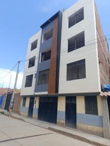 an apartment building on the corner of a street at casa SKALA in Puno