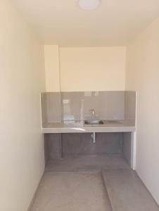 a bathroom with a sink in the corner of a room at casa SKALA in Puno