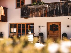 a room with a table and a wooden door at Sportony Mountain Lodges in La Villa