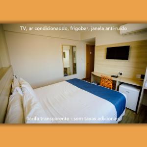 Un pat sau paturi într-o cameră la Luds Comfort Hotel