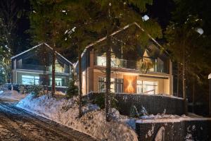 a home in the snow at night at Buko Village by Fomich in Bukovel