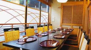 a dining room with a long table and chairs at Albert Hotel in Akita