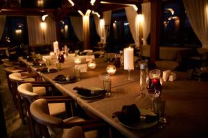 a long table in a restaurant with candles and wine glasses at Waterloo Village in Pidhorodne