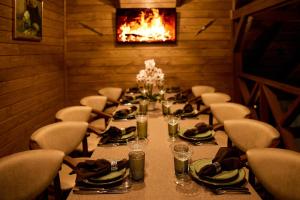 a room with a long table with chairs and a fireplace at Waterloo Village in Pidhorodne