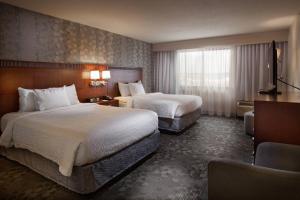 a hotel room with two beds and a window at Courtyard by Marriott Fayetteville in Fayetteville