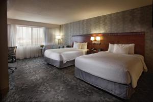 a hotel room with two beds and a window at Courtyard by Marriott Fayetteville in Fayetteville