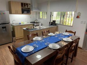 a kitchen with a table with plates and wine glasses at Magnolio in Colonia del Sacramento