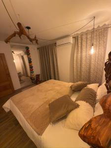 a bedroom with a large bed with pillows on it at Cas'A Ferreirinha - Your Home In Douro in Peso da Régua