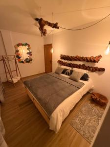 a bedroom with a large bed with a wooden headboard at Cas'A Ferreirinha - Your Home In Douro in Peso da Régua