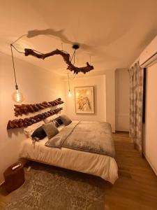 a bedroom with a bed with a branch on the ceiling at Cas'A Ferreirinha - Your Home In Douro in Peso da Régua