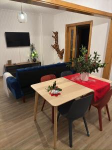 a living room with a table and a blue couch at Cas'A Ferreirinha - Your Home In Douro in Peso da Régua