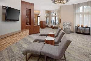 a living room with couches and a flat screen tv at Courtyard by Marriott Houma in Houma