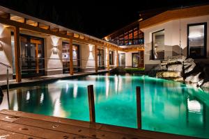 a swimming pool in front of a building at night at Hotel Horal in Rožnov pod Radhoštěm