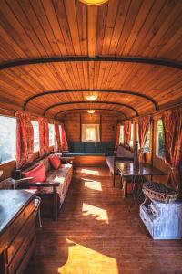 a living room with couches and tables in a train car at Aphrodite's Inn Kalavrita in Kalavrita