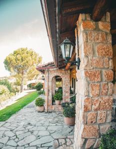 a stone house with a light on the side of it at Aphrodite's Inn Kalavrita in Kalavrita