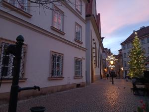 un albero di Natale in una strada accanto a un edificio di Betlem Prague Apartments a Praga