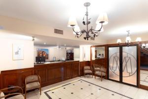 a large room with a lobby with a desk and chairs at Hotel Colonial Salta in Salta