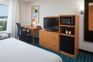 a hotel room with a bed and a television and a desk at Fairfield Inn and Suites by Marriott Conway in Conway