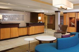 a lobby with a waiting area with chairs and tables at Fairfield Inn and Suites by Marriott Conway in Conway