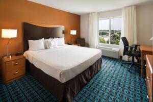 a hotel room with a bed and a desk and a window at Fairfield Inn and Suites by Marriott Conway in Conway