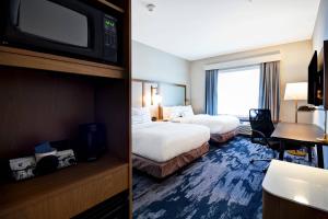 a hotel room with two beds and a television at Fairfield Inn & Suites by Marriott Plymouth in Plymouth