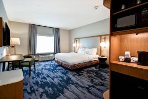 a hotel room with a bed and a desk at Fairfield Inn & Suites by Marriott Plymouth in Plymouth