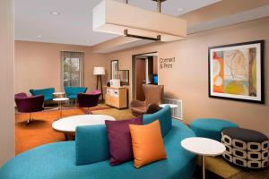 a waiting room with a blue couch and chairs at Fairfield Inn & Suites by Marriott Albuquerque Airport in Albuquerque