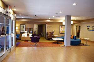 a lobby of a hotel with blue chairs and a table at Fairfield Inn & Suites by Marriott Albuquerque Airport in Albuquerque