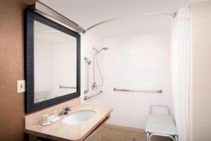 a bathroom with a sink and a mirror at Fairfield Inn & Suites by Marriott Albuquerque Airport in Albuquerque